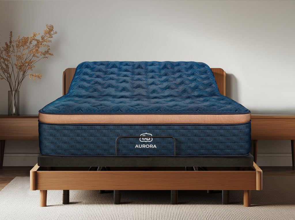 Blue mattress on the Ascension® Ultra Adjustable Power Base with the head section raised inside a wood bed frame.