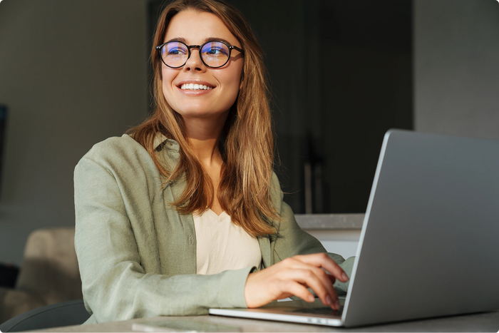 Woman using a laptop with a blurred background